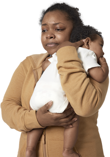 Black woman with a depressed expression on her face while holding newborn baby.